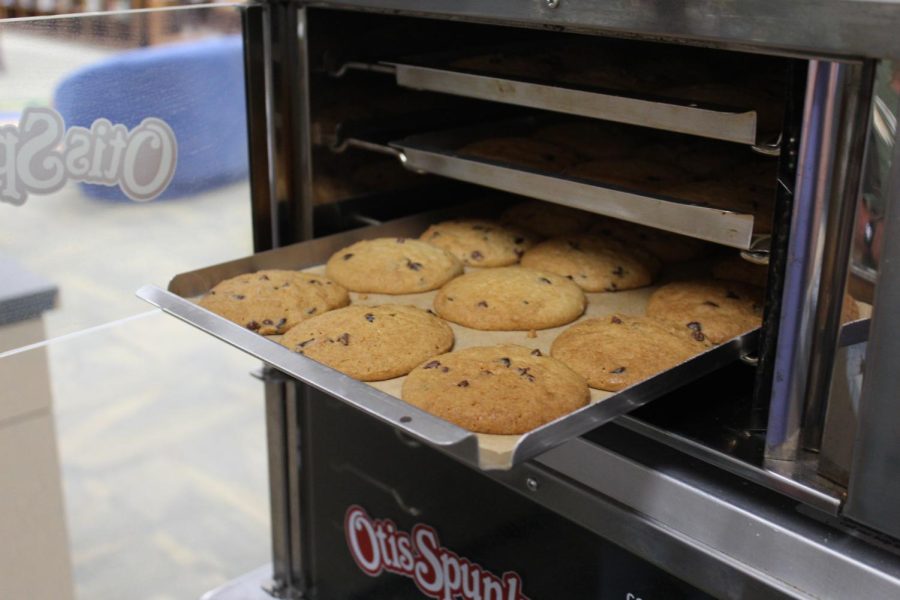 Cookies being pulled fresh out the oven. 